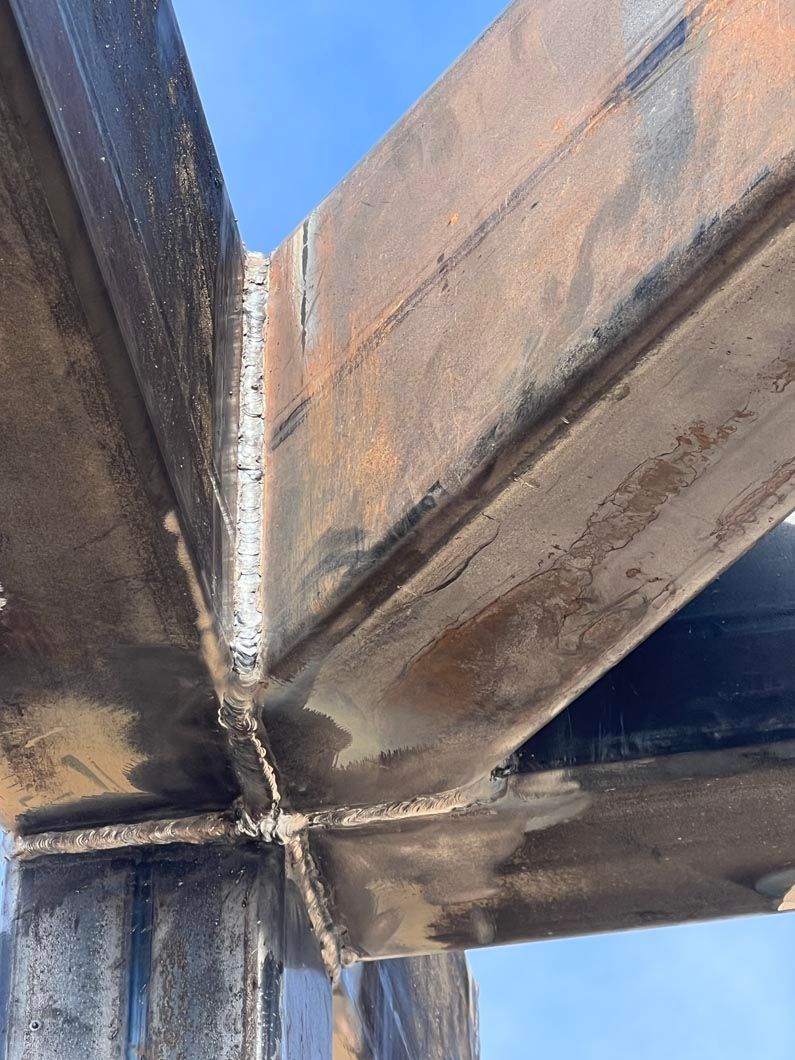 A close up of a metal structure with a blue sky in the background.