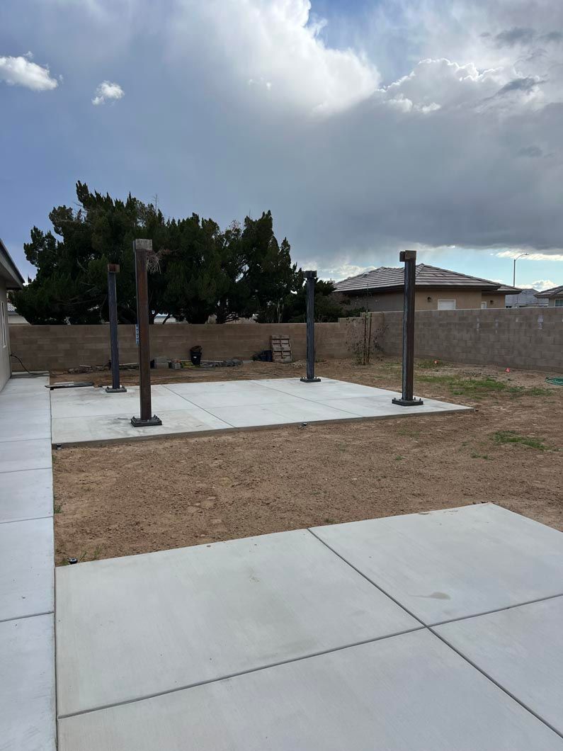 A concrete patio with a house in the background