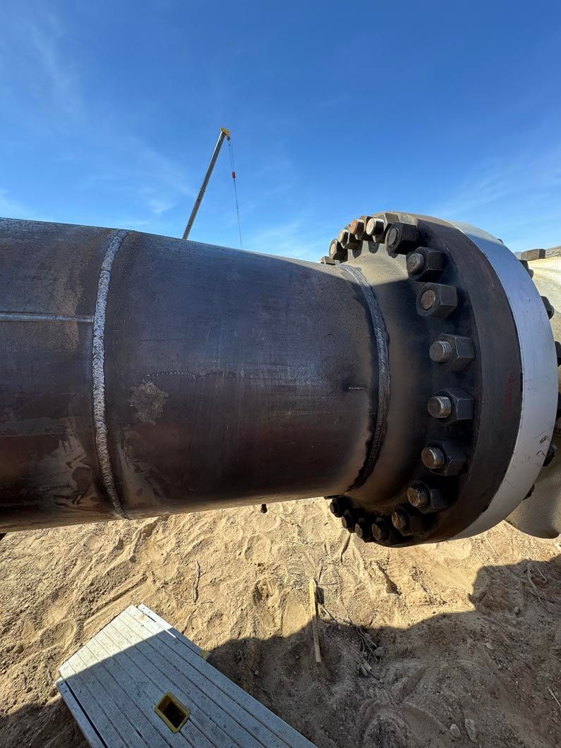 A close up of a metal pipe with a flange on it.
