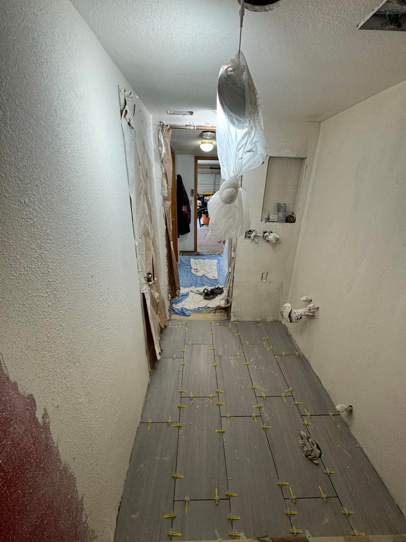 A long hallway with a ceiling that is being remodeled.