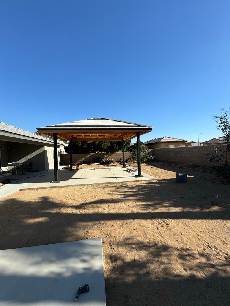 A backyard with a pavilion in the middle of it.