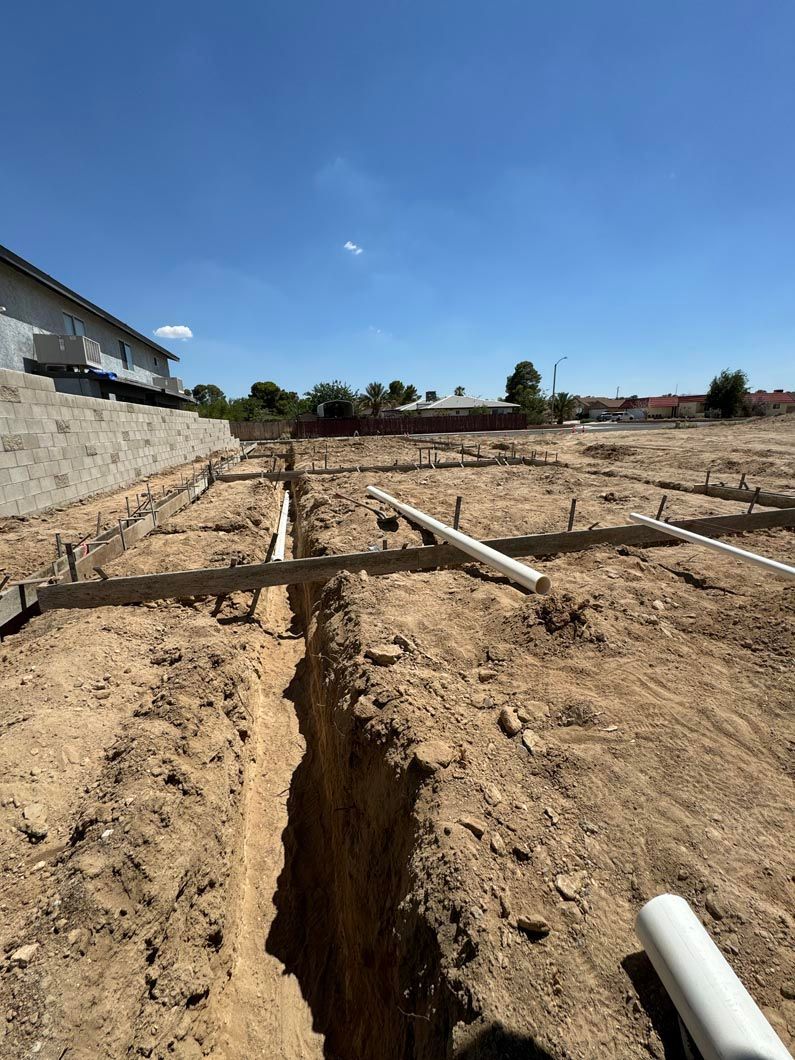A large hole in the ground with pipes coming out of it.