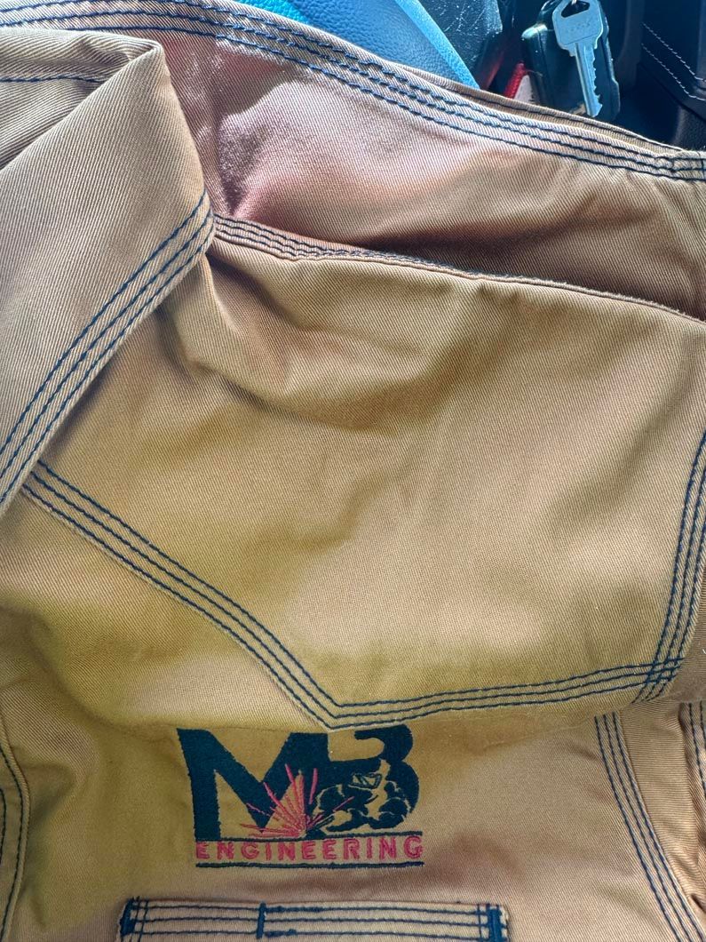 A close up of a piece of cloth with the letter m on it.