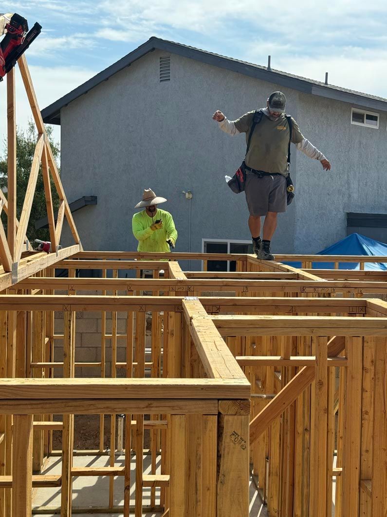 A man is standing on top of a wooden structure.