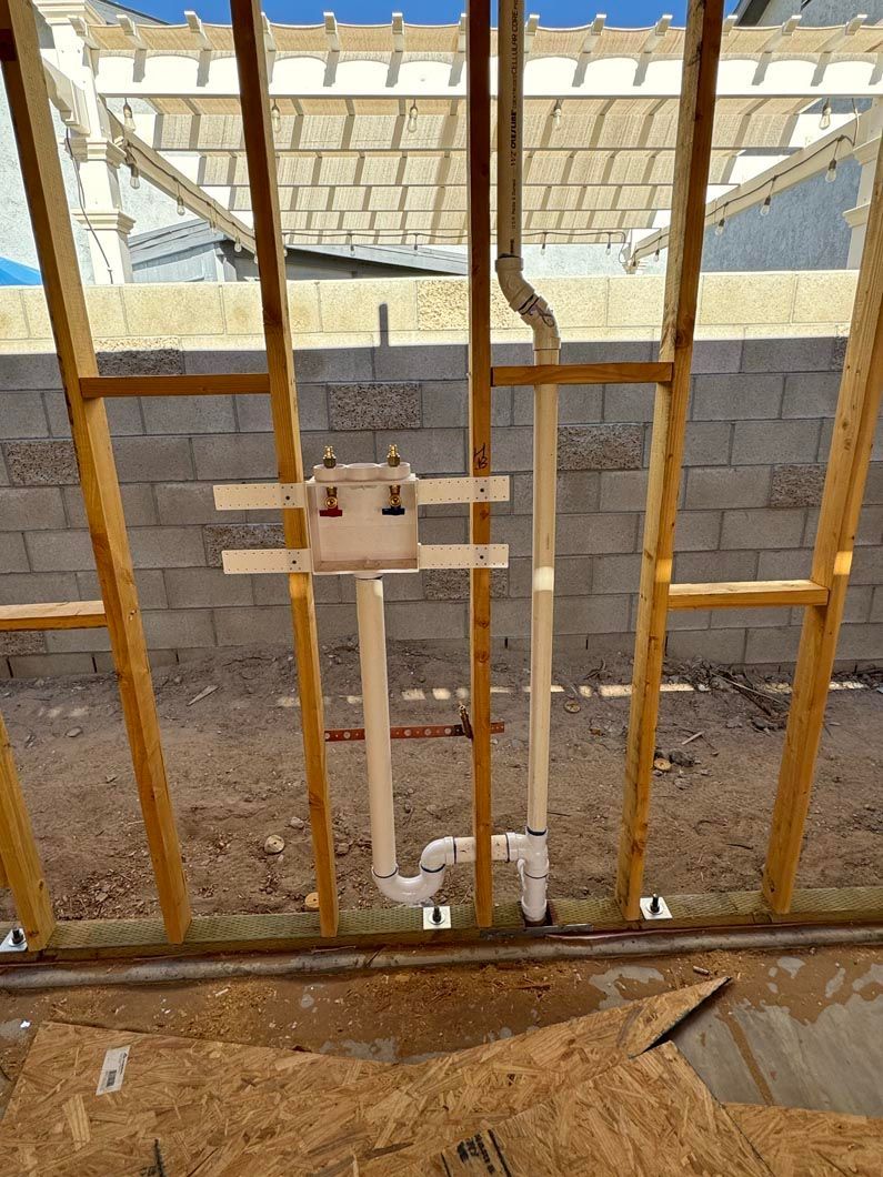 A wooden frame with pipes coming out of it.