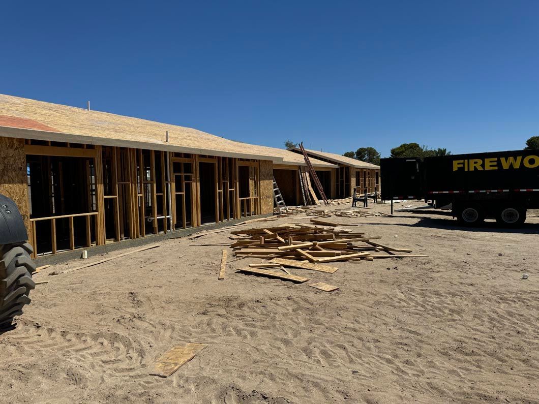 A firewood truck is parked in front of a building under construction