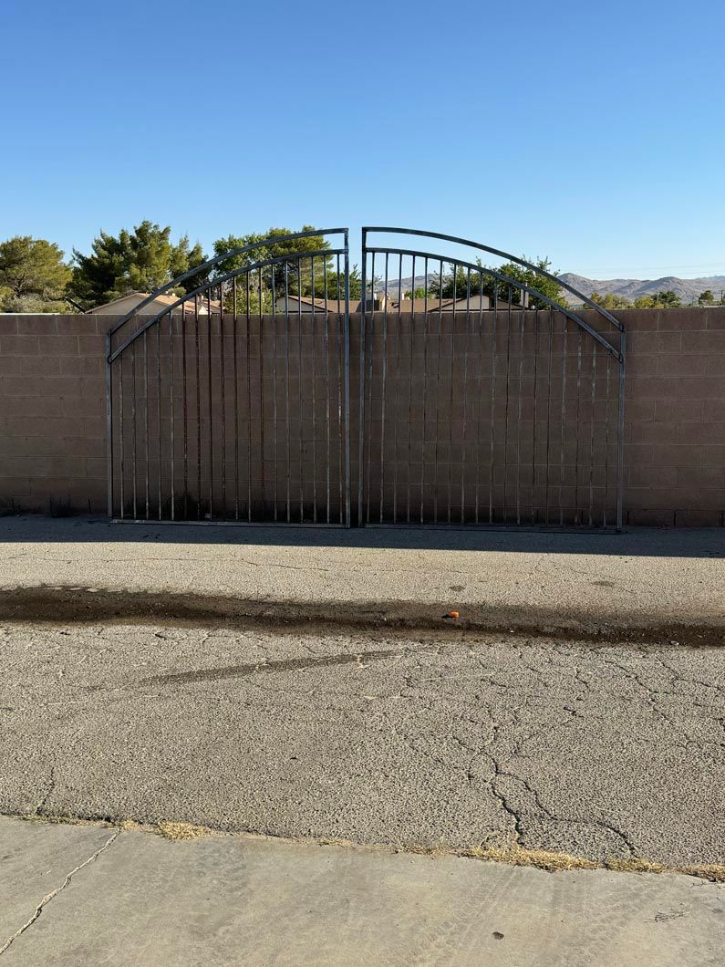 A brick wall with a metal gate in front of it