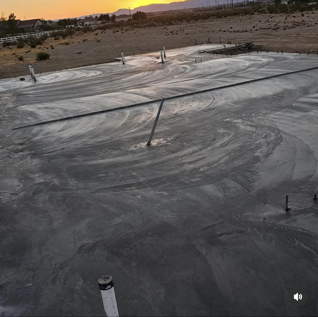 An aerial view of a concrete floor with a sunset in the background.