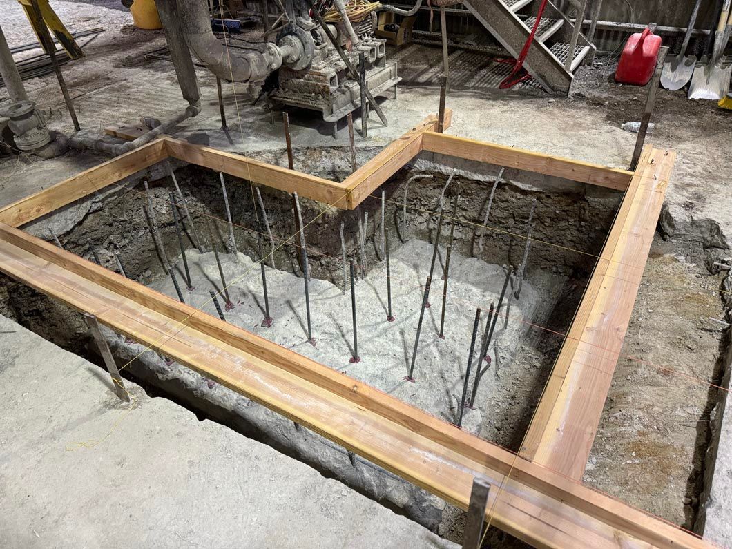 A large hole in the ground with a wooden frame around it.