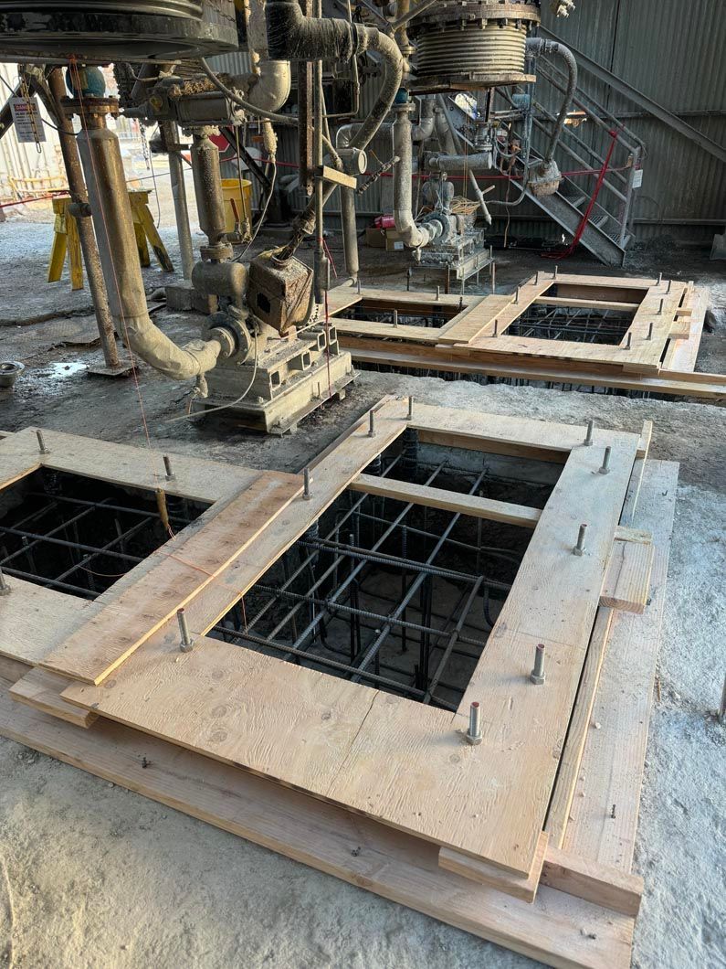 A group of wooden boards sitting on top of each other on a construction site.