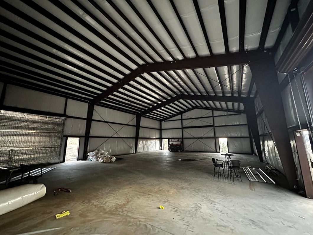 A large warehouse with a table and chairs inside of it.