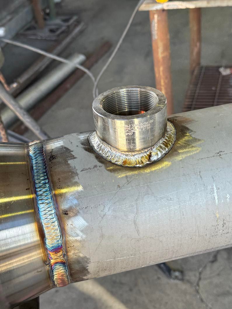 A close up of a metal pipe with a hole in it.