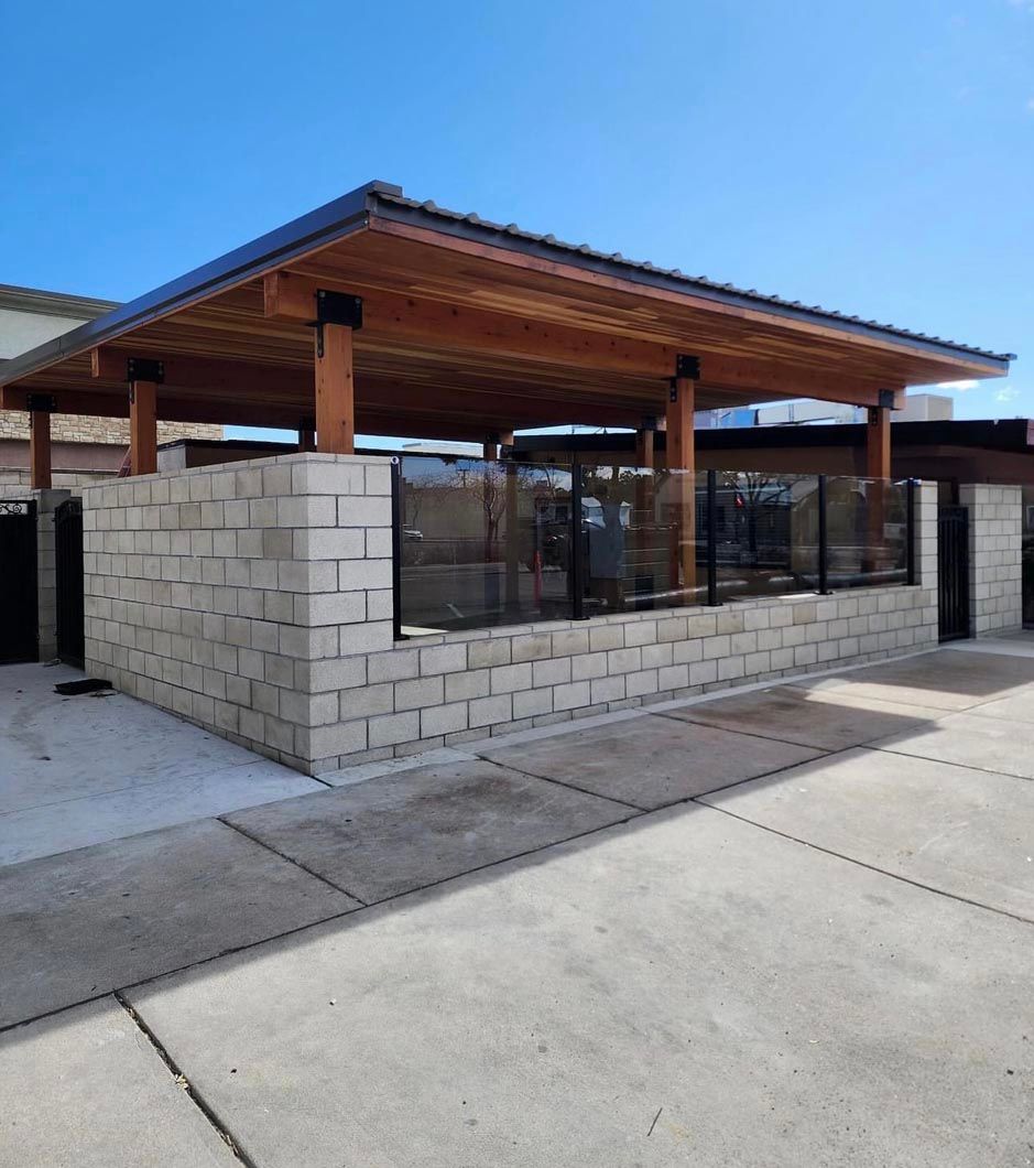 A brick building with a wooden roof and a lot of windows