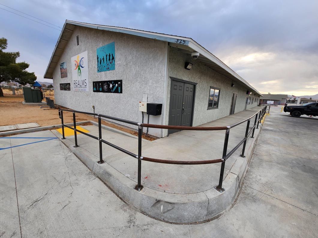 A large white building with a metal railing on the side of it.