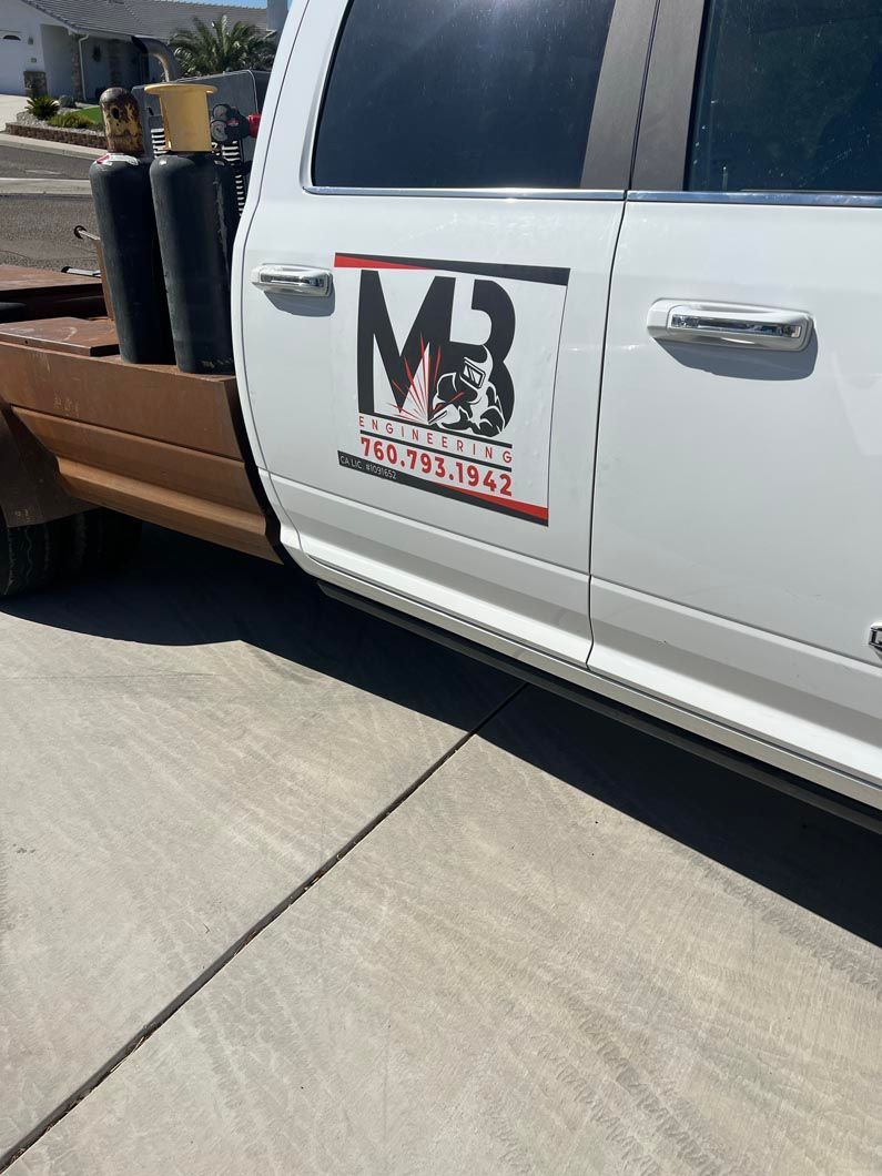 A white truck is parked on the side of the road.