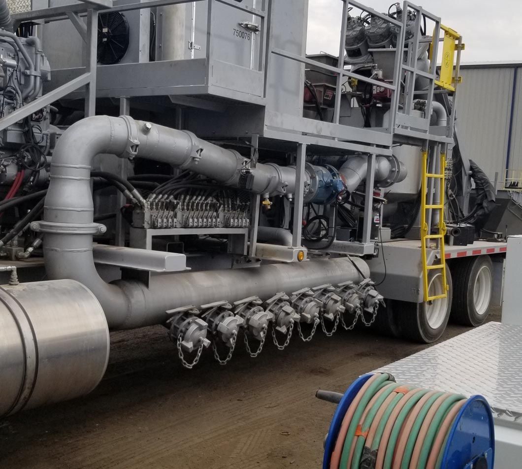 A truck with a bunch of pipes on it