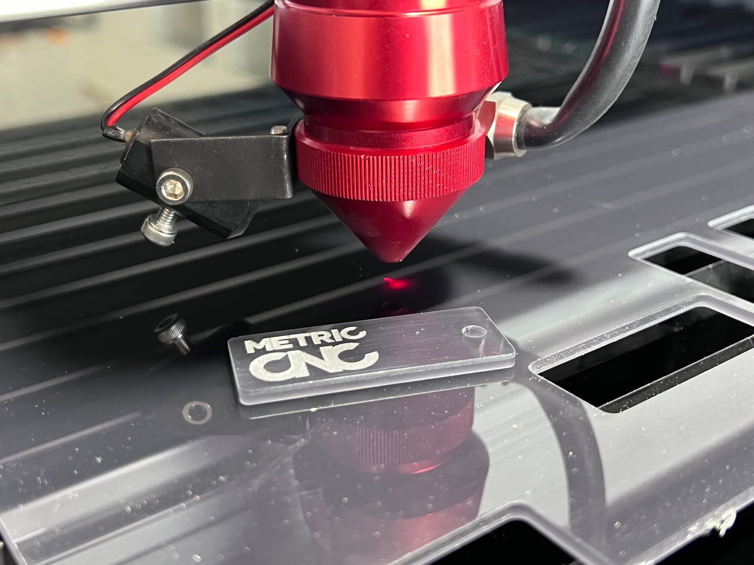 A Laser Cutting Machine Is Cutting A Piece Of Acrylic —Metric CNC In Morisset, NSW