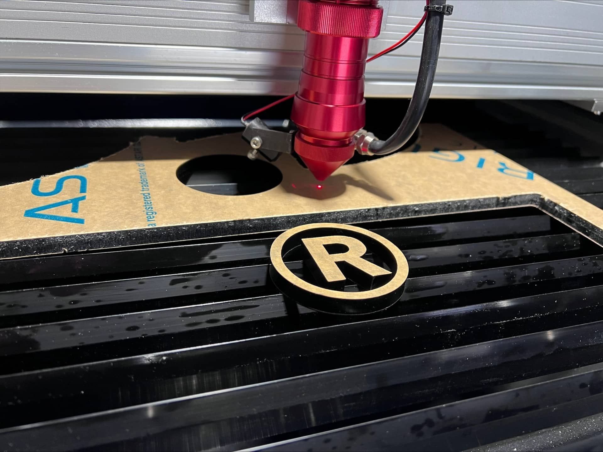 A Machine Is Cutting A Piece Of Wood On A Table — Metric CNC In Newcastle, NSW
