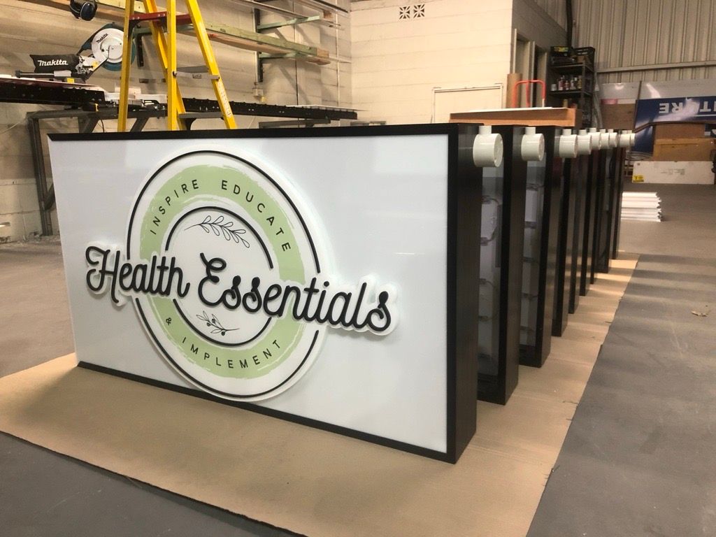 A Sign for Health Essentials is Sitting on a Table in a Room — Metric CNC In Morisset, NSW