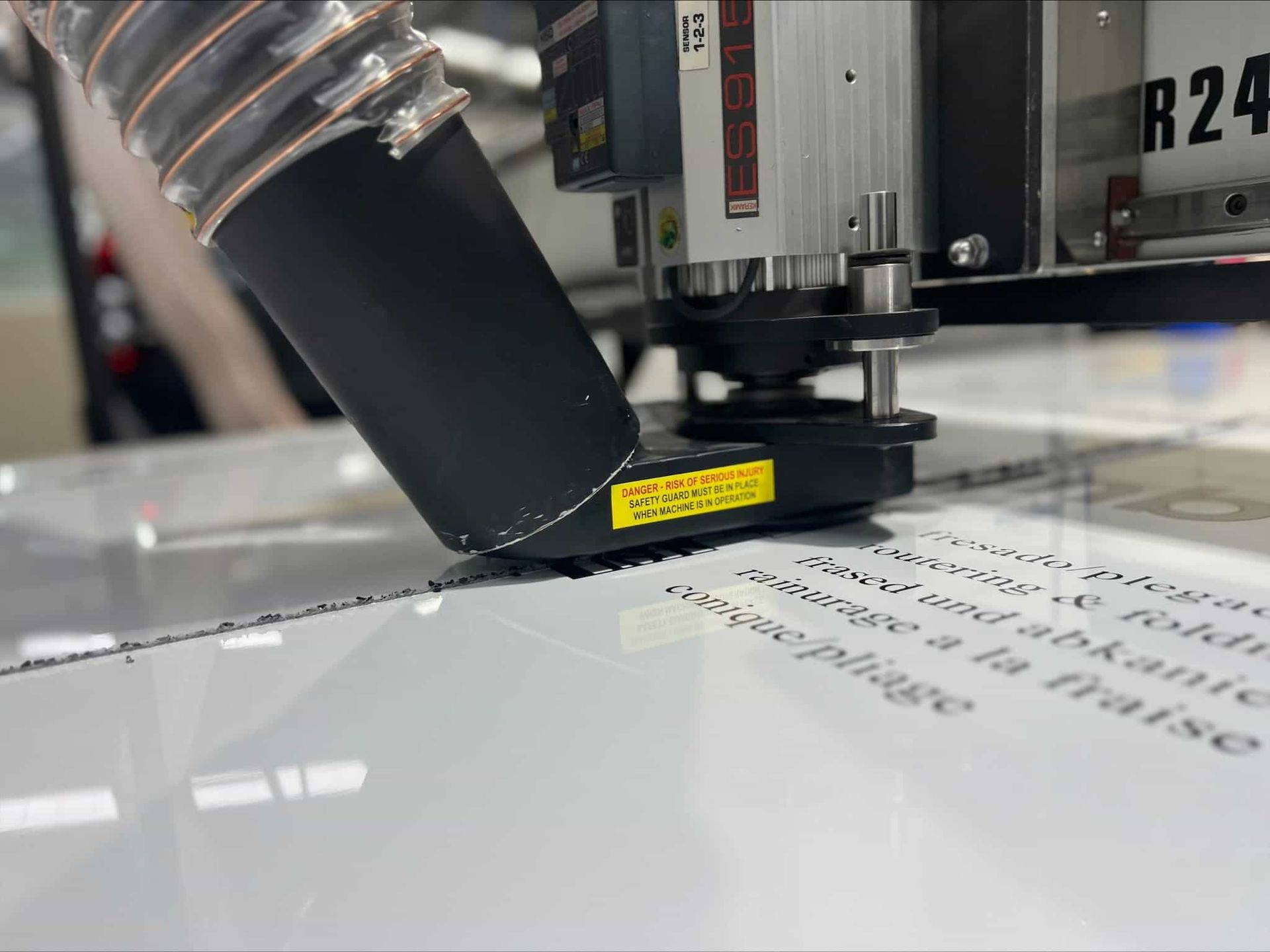 A Machine Is Cutting A Piece Of Paper On A Table — Metric CNC In Morisset, NSW
