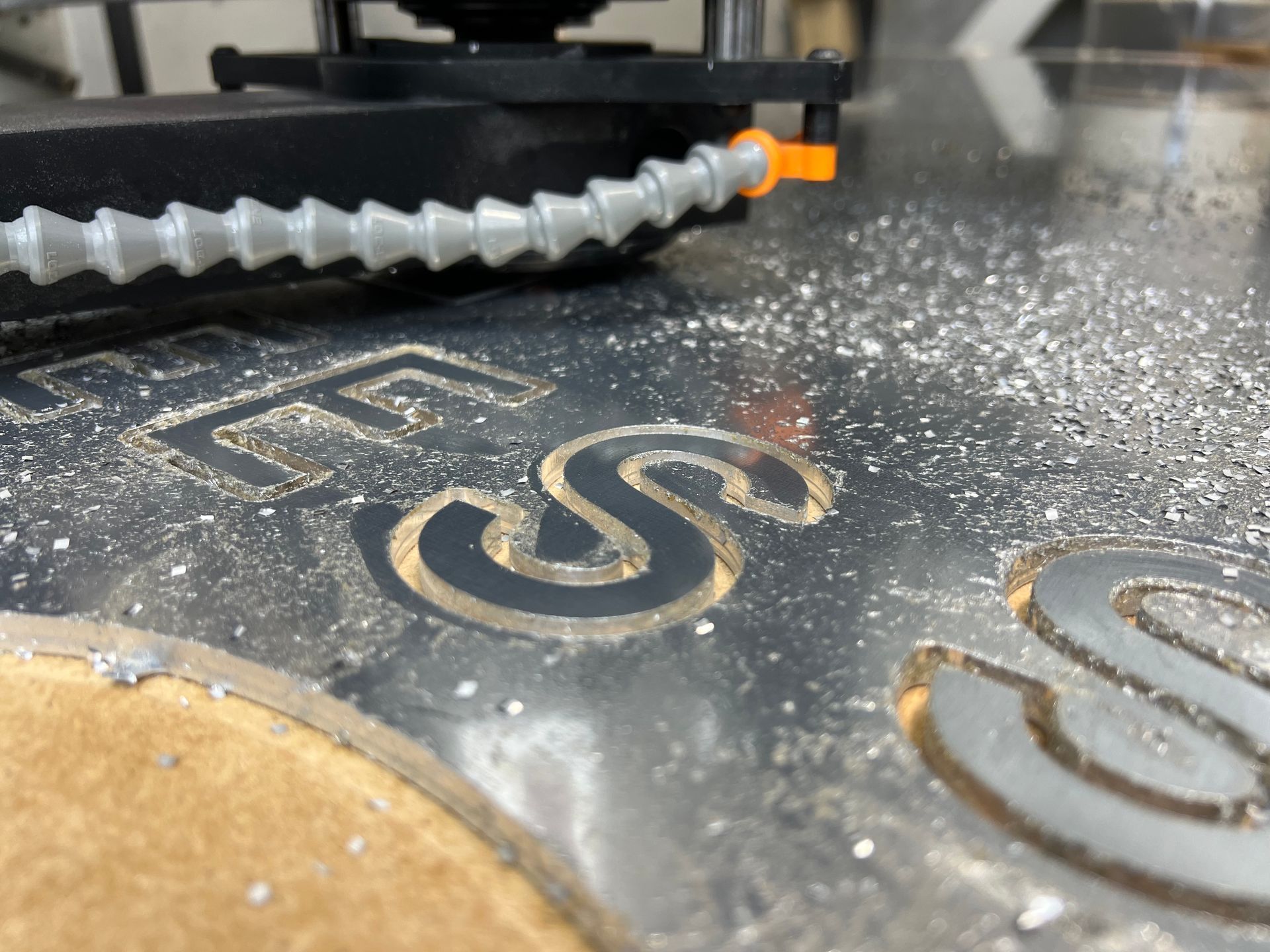 A Machine Is Cutting A Piece Of Metal In The Shape Of An S — Metric CNC In Newcastle, NSW
