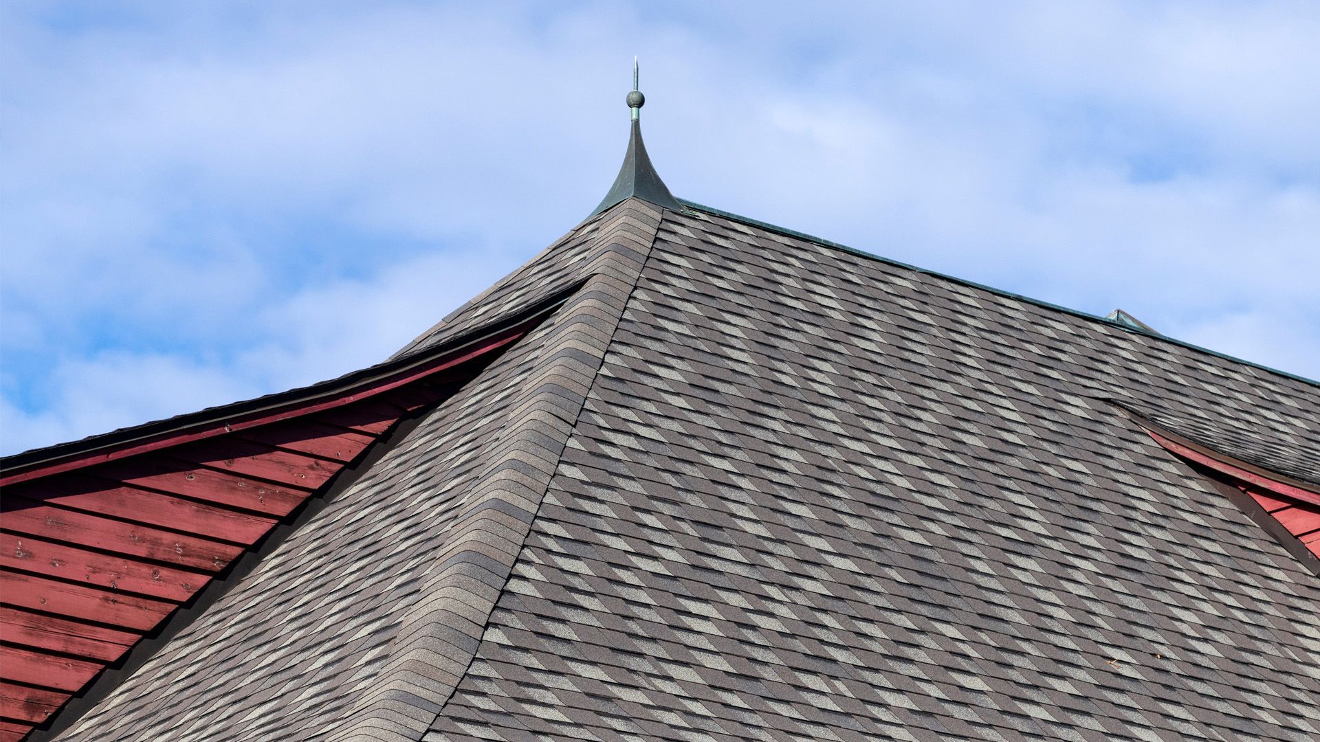 the roof of a building with a cross on top of it .