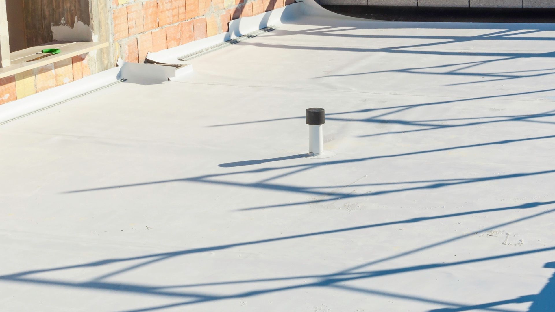 a white roof with a black pipe on top of it .