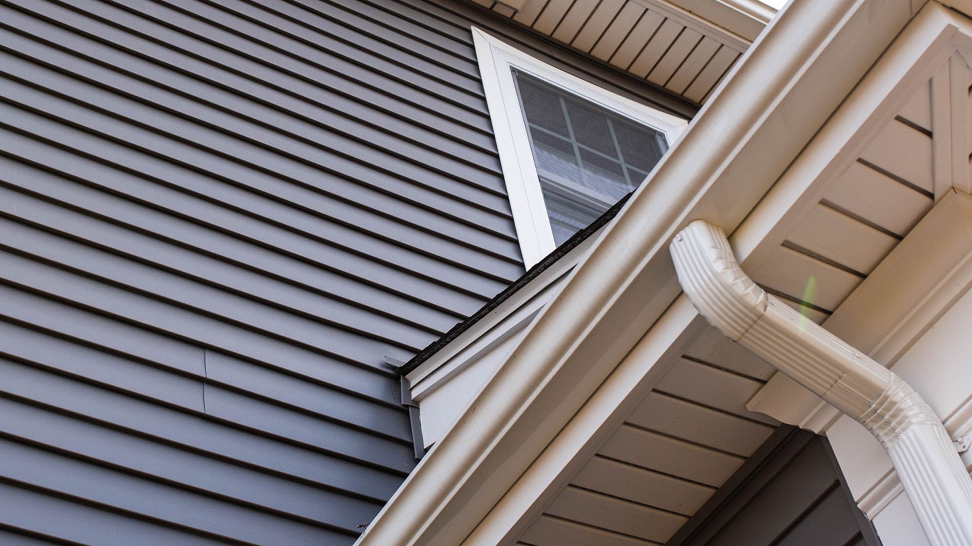 looking up at the roof of a house with a window