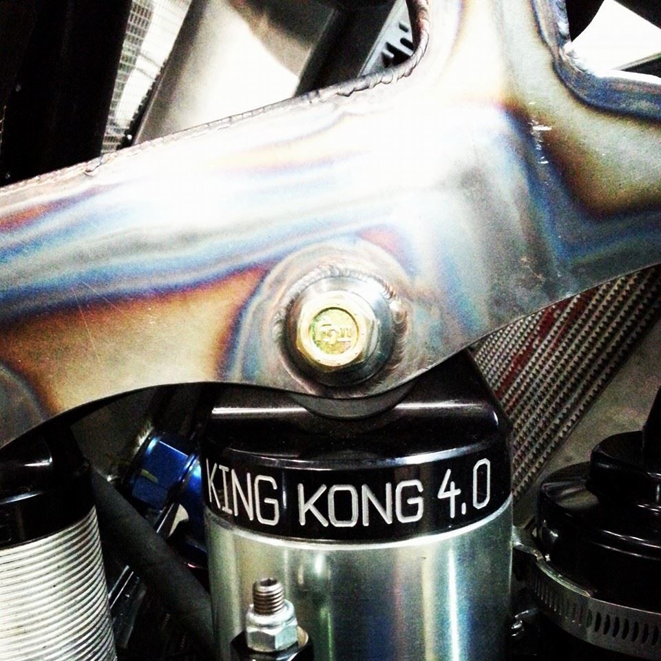 Close-up of a bike frame and shock labeled “KING KONG 4.0” with metallic tubing and bolts