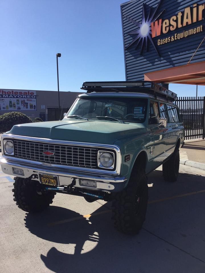 Lifted vintage Chevrolet SUV parked outside WestAir Diesel & Emissions sign