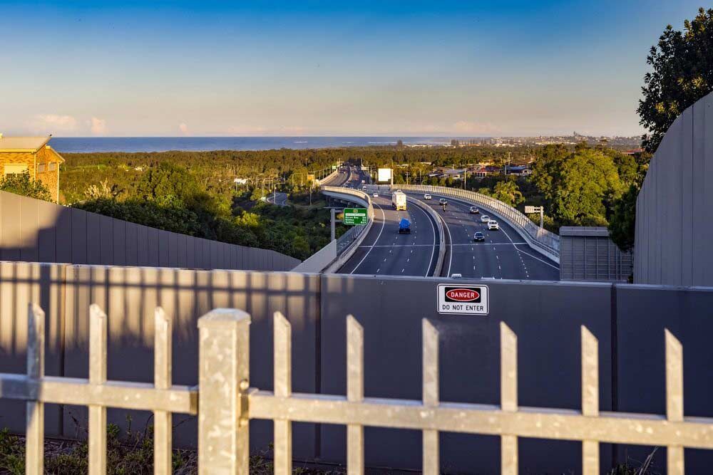 A View Of A Highway From Behind A Fence — Kingscliff Tweed Coast Taxis Pty Ltd In Banora Point, NSW