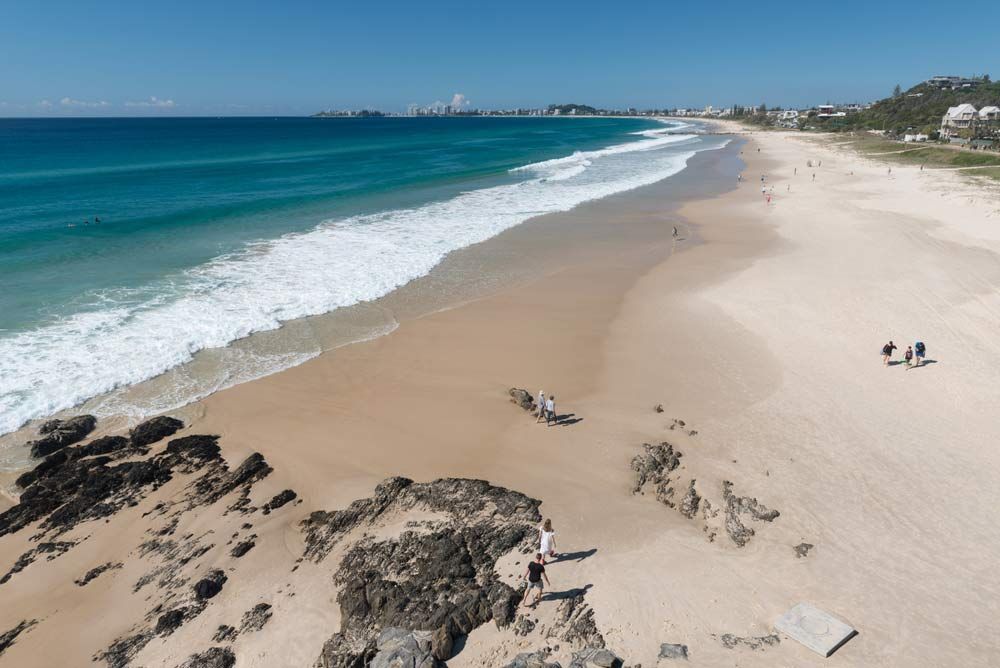An Aerial View Of A Beach With Waves Crashing On The Shore — Kingscliff Tweed Coast Taxis Pty Ltd In Tugun, QLD