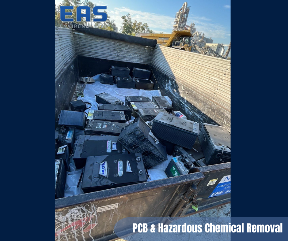 Black containers filled with batteries, labeled 