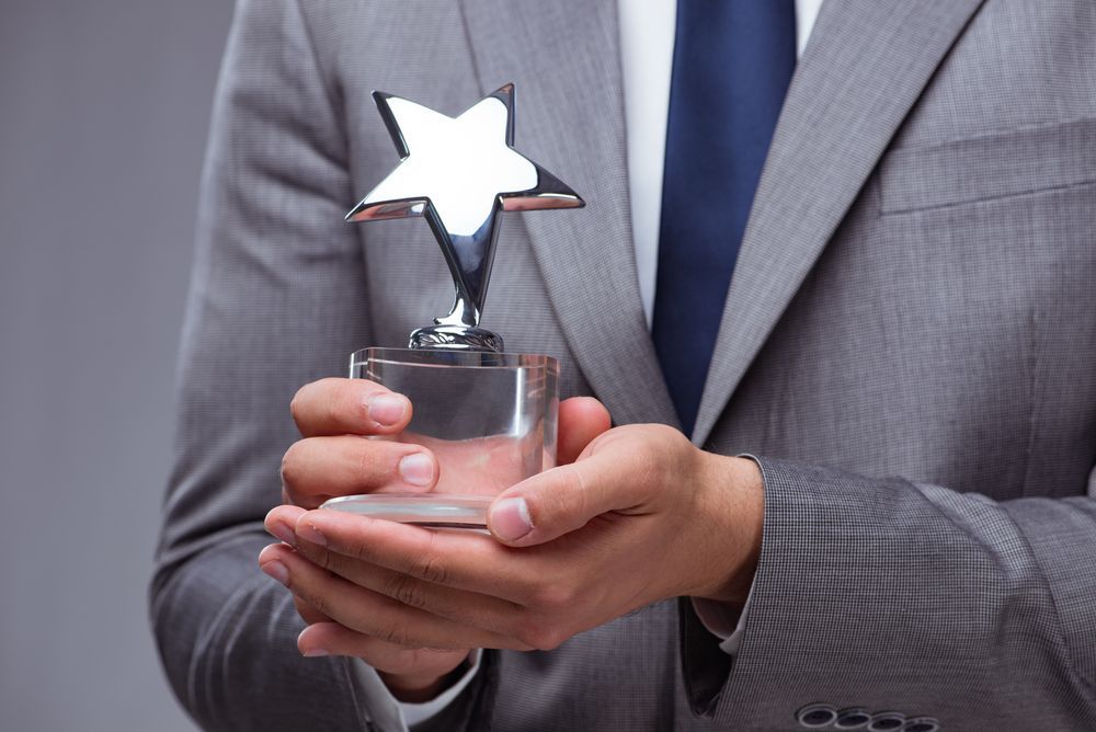 employee holding an award