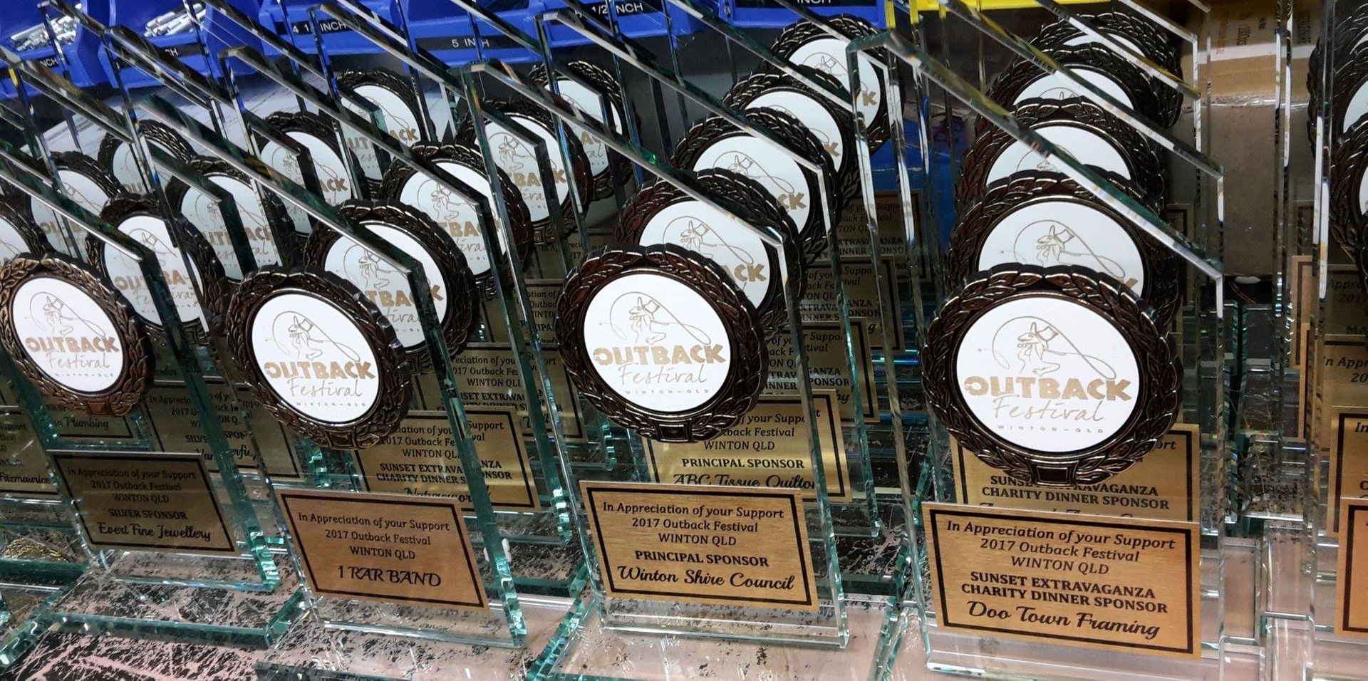 Rows of Glass Trophies With Circular Metal Accents