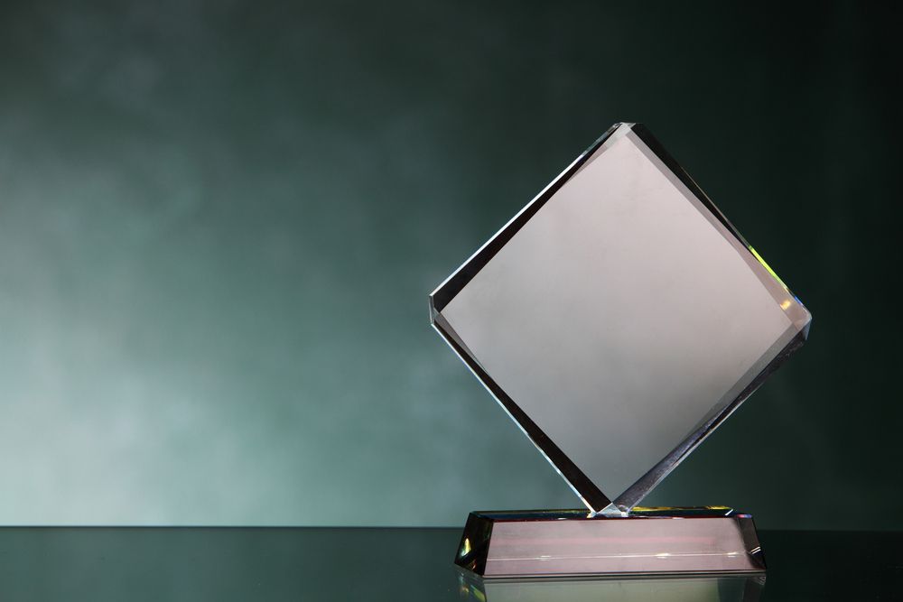 A Diamond Shaped Glass Trophy Is Sitting On A Glass Table — NQ Plaques & Trophies In Mount Isa, QLD