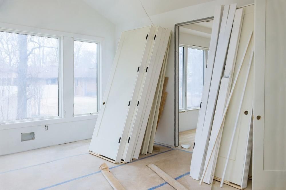 a room with a lot of doors painted stacked on top of each other .