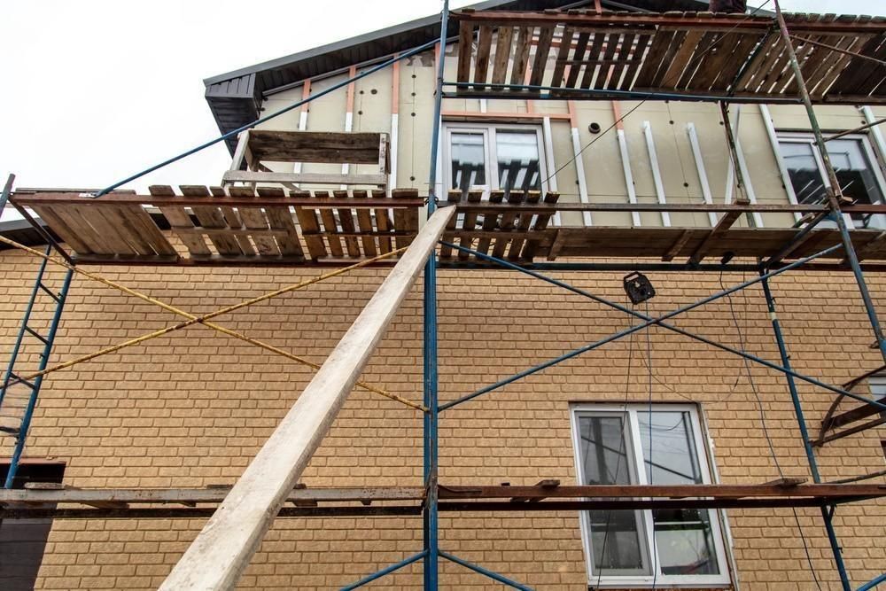 a brick building is being built with scaffolding around it .