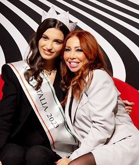 Due donne posano per una foto con una che indossa una fascia con la scritta miss italia 2023