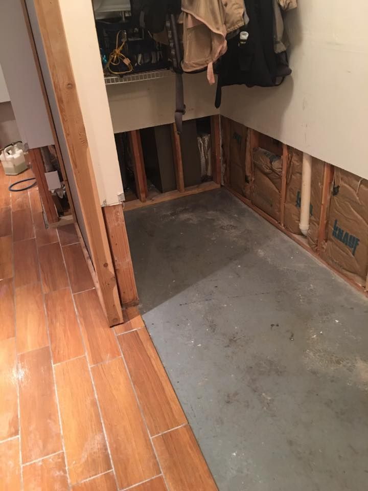 A room with a wooden floor and a concrete floor.