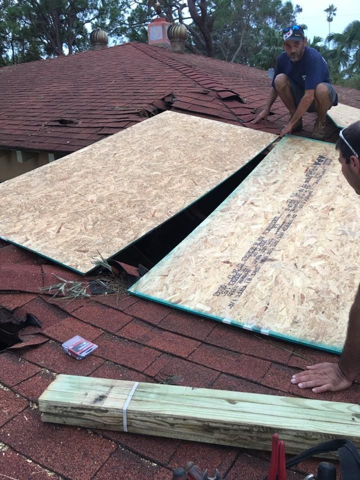 A man is working on the roof of a house