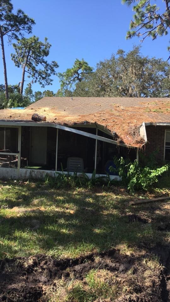 A house with a roof that has been damaged by a storm.