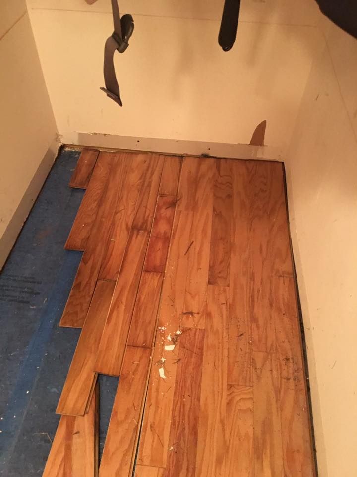 A wooden floor is being installed in a room.