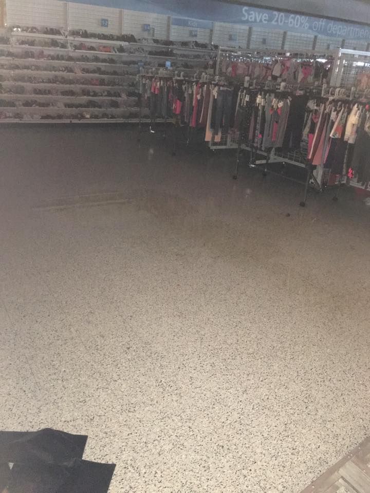 An empty store with a lot of clothes on display.