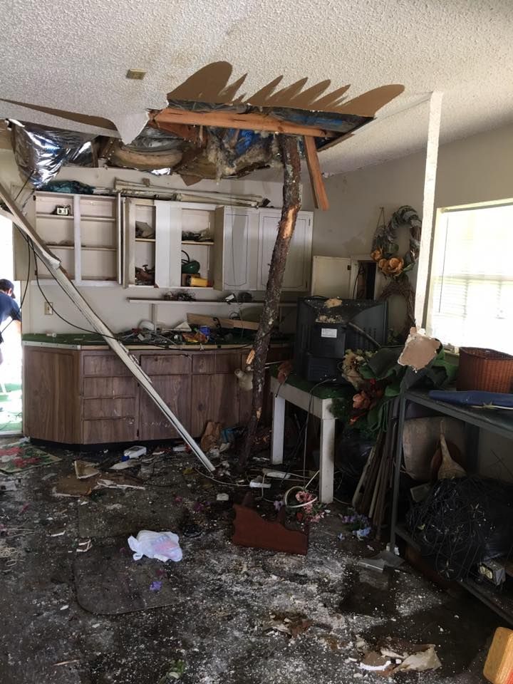 A kitchen in a house that has been damaged by a tornado.
