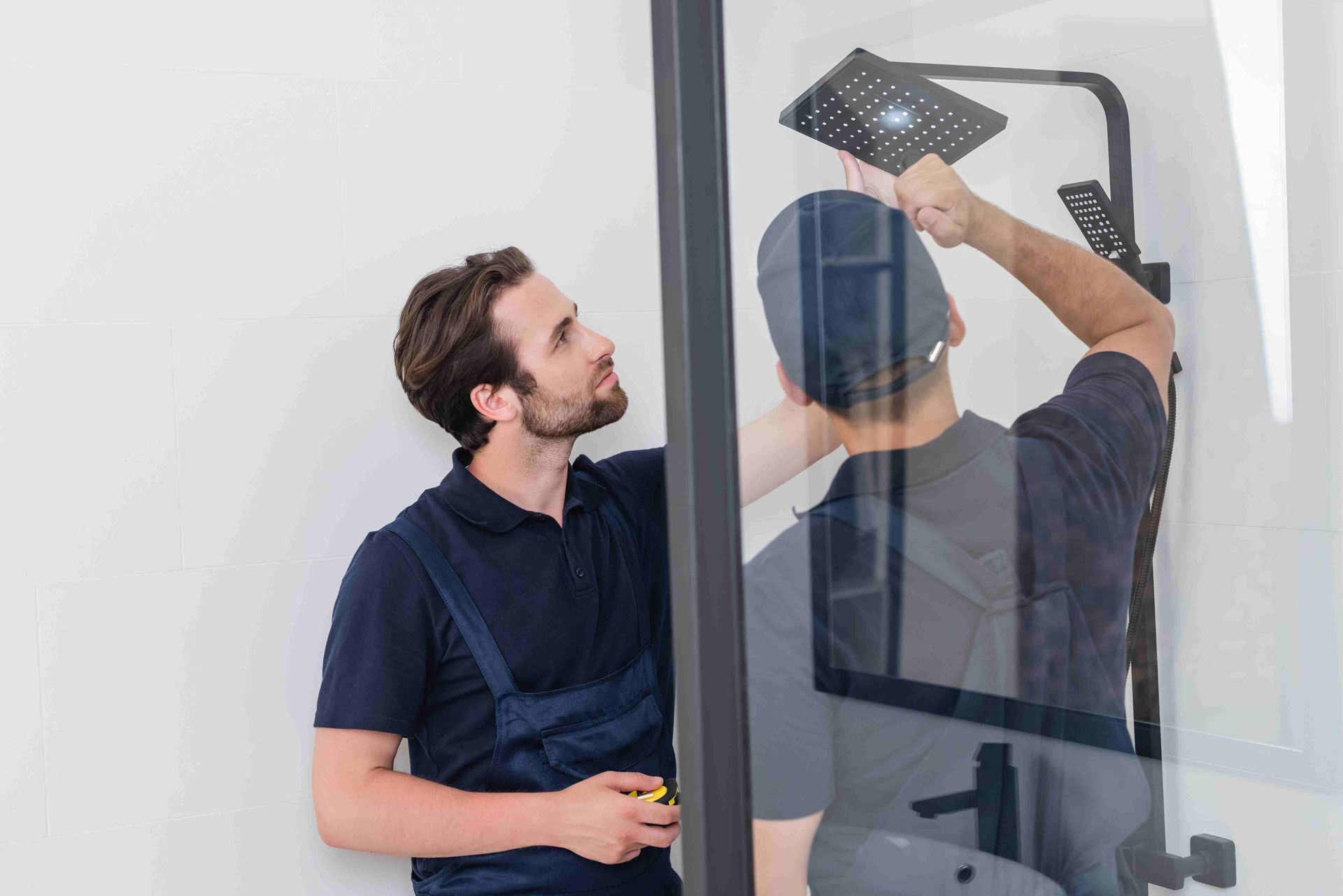 A man installing a new shower head