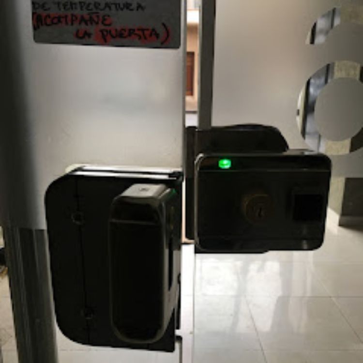 Una cerradura electrónica para puerta de cristal con un indicador luminoso verde encendido.