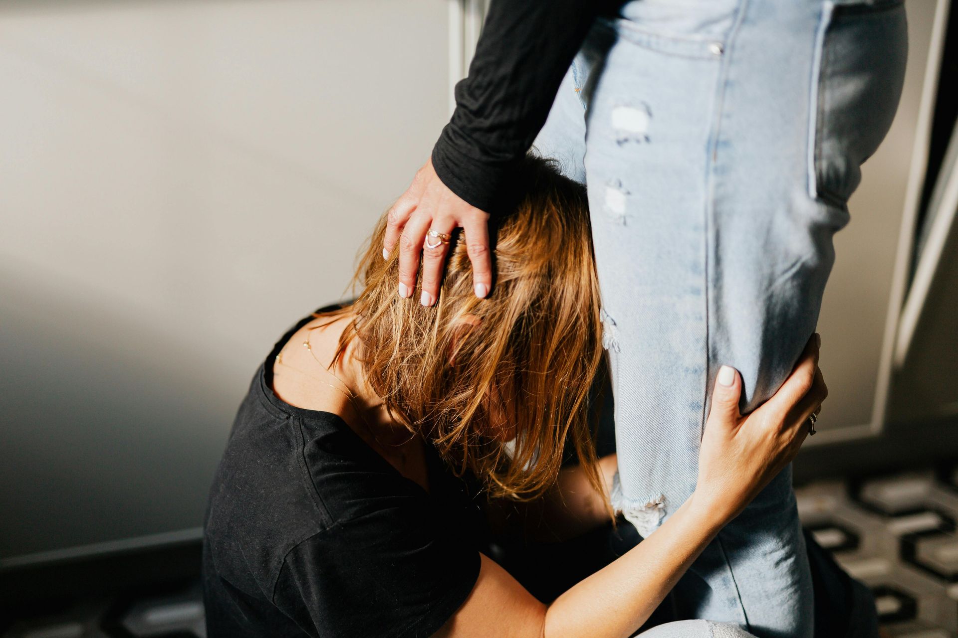 Heartbreak, woman hanging on to man