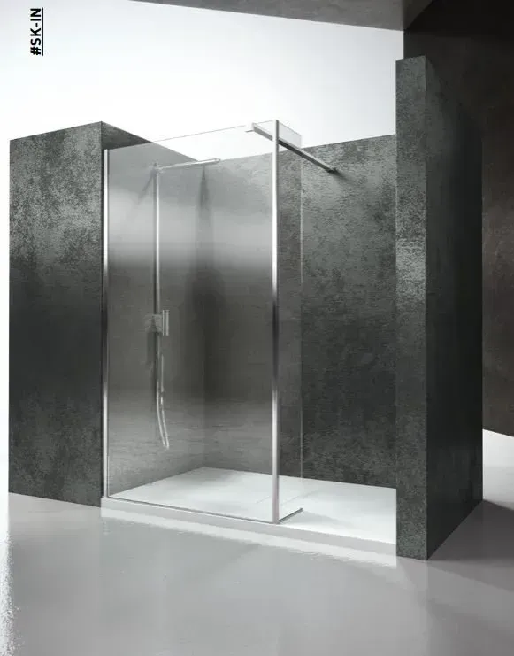 Box doccia con porta in vetro e telaio argentato, incastonato tra due pareti grigio scuro, pavimento bianco.