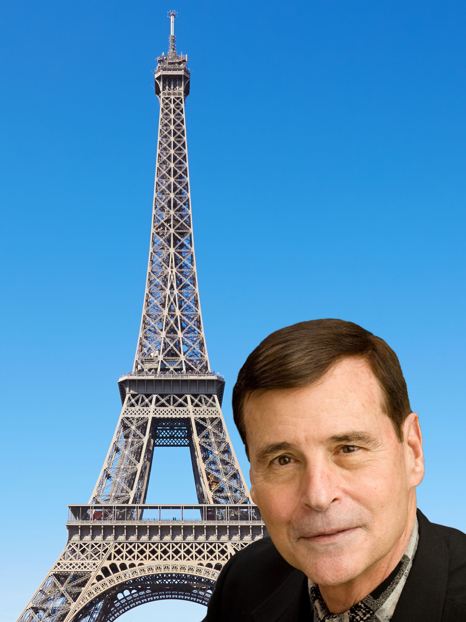 A man stands in front of the eiffel tower